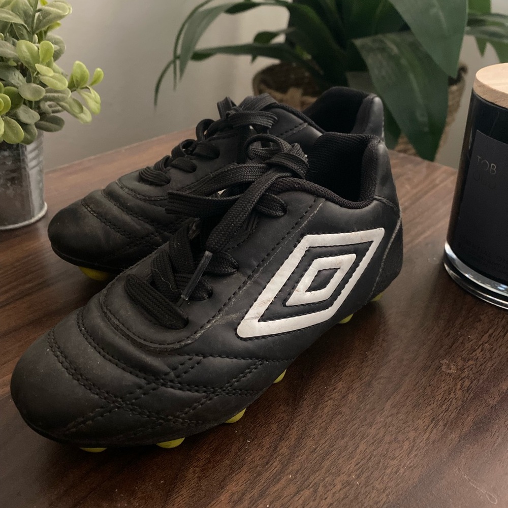 Umbro Black Soccer Cleats with Molded Studs and Textured Surface